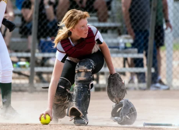 Softball player fielding the ball